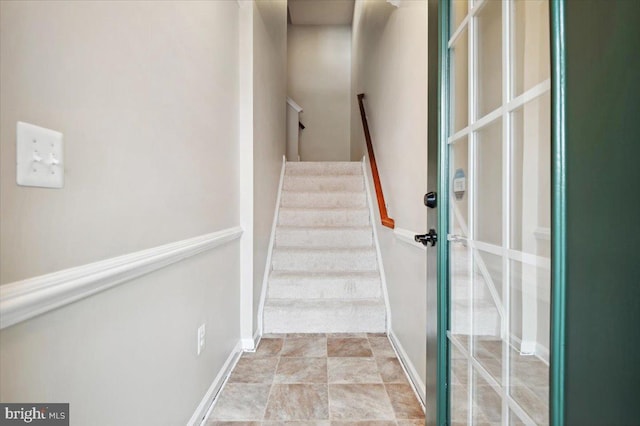 stairs featuring baseboards