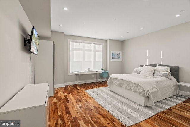 bedroom featuring recessed lighting, baseboards, and wood finished floors