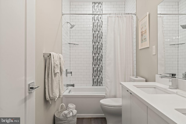 bathroom featuring shower / tub combo with curtain, vanity, and toilet