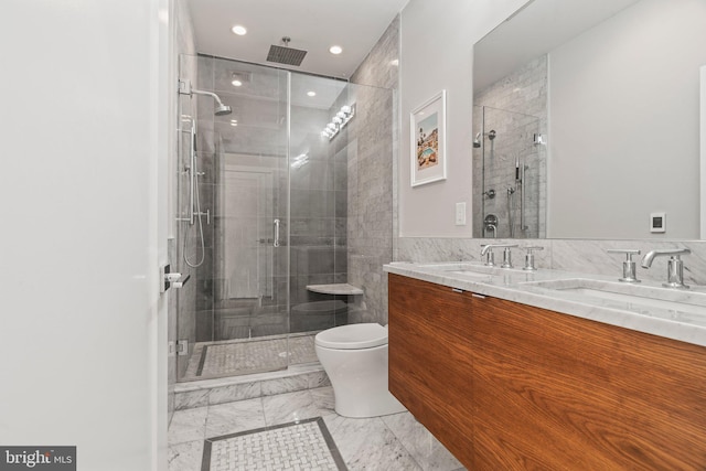 full bath featuring double vanity, toilet, marble finish floor, a shower stall, and a sink