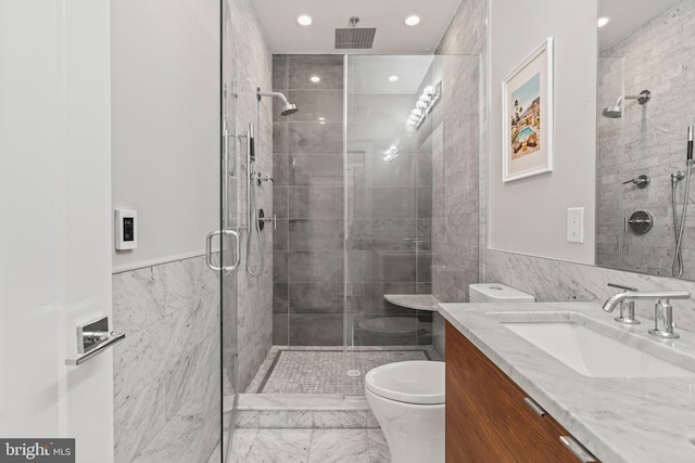 full bathroom featuring vanity, a shower stall, toilet, and tile walls