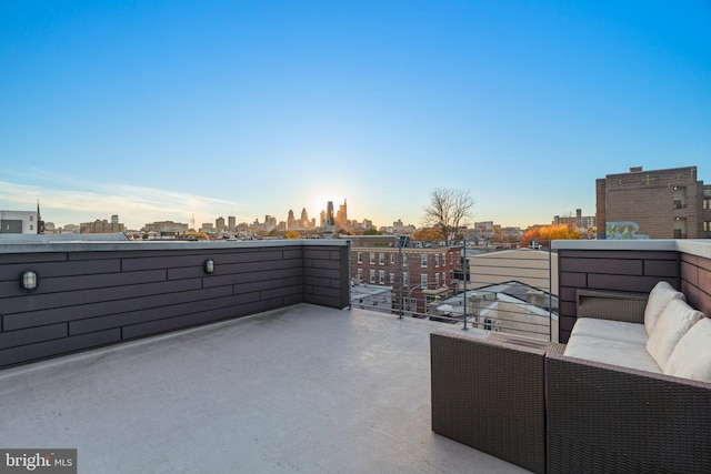 view of patio with a balcony, an outdoor living space, and a city view