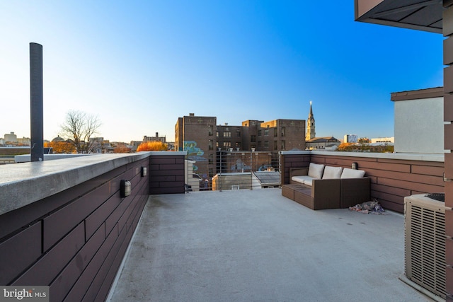 view of patio / terrace featuring a view of city, cooling unit, and an outdoor living space