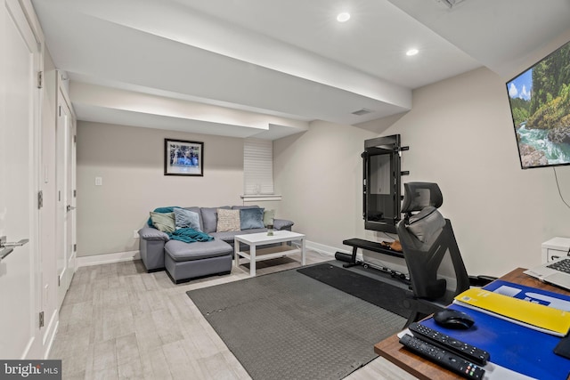 exercise area with recessed lighting, baseboards, and light wood finished floors