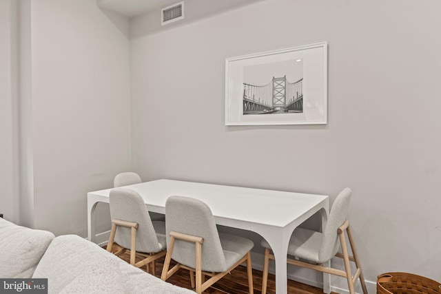 dining area with wood finished floors and visible vents