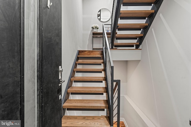 stairs with wood finished floors