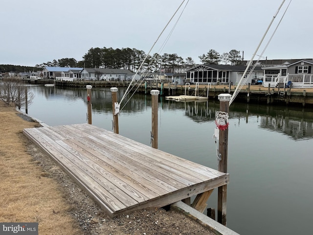 dock area with a residential view and a water view