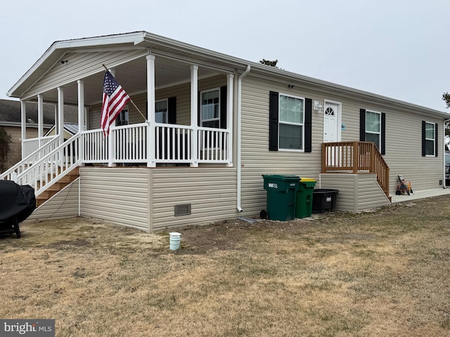 manufactured / mobile home with crawl space and a front lawn