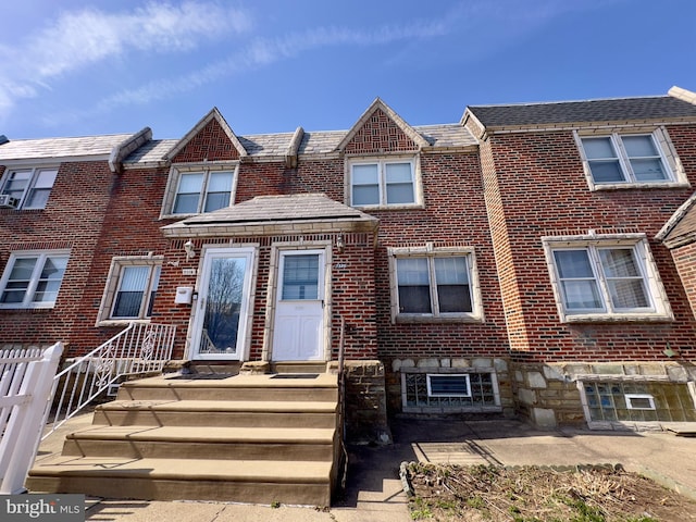 townhome / multi-family property with brick siding