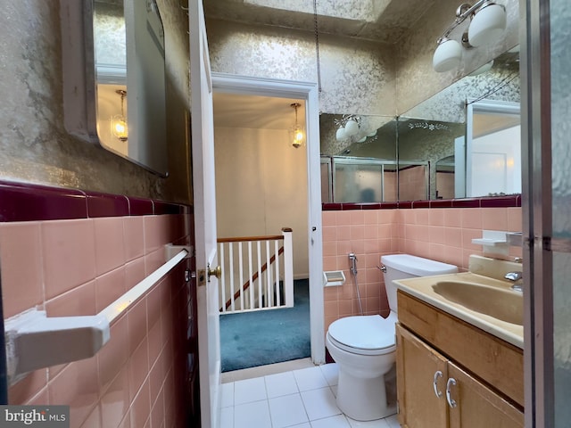 bathroom featuring vanity, tile walls, toilet, and tile patterned floors