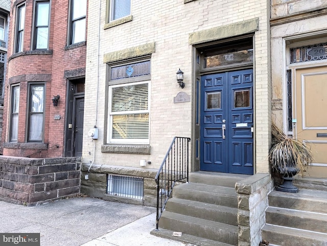 property entrance with brick siding