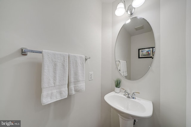 bathroom with visible vents and a sink