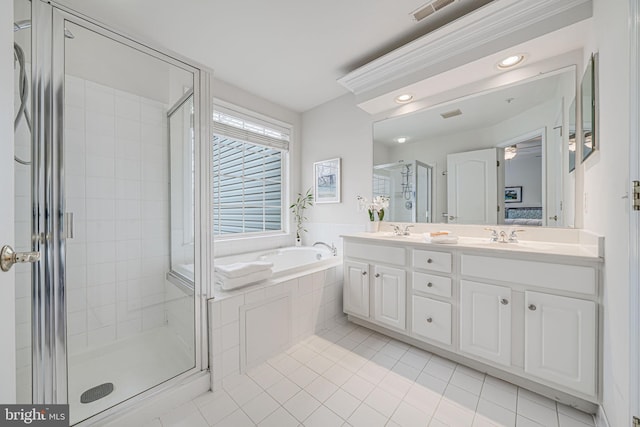 full bathroom featuring ensuite bathroom, a stall shower, tile patterned flooring, and a sink