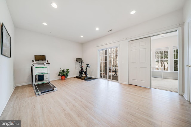 exercise room with plenty of natural light, light wood-style flooring, and recessed lighting