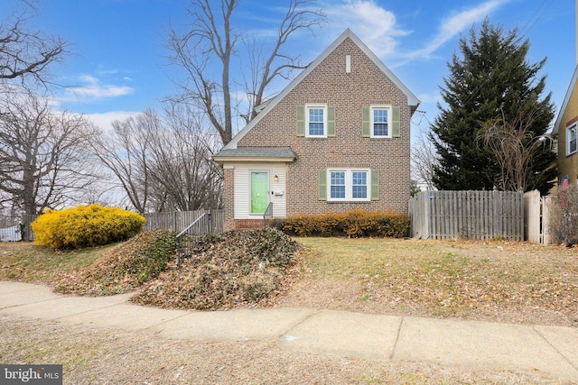 traditional-style home with brick siding and fence