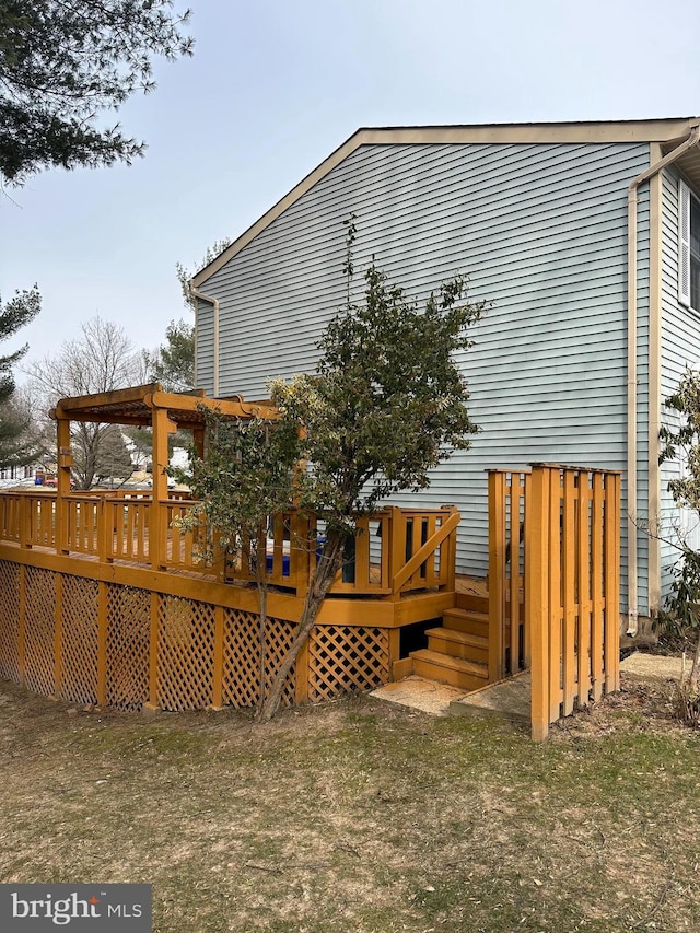 back of house featuring a wooden deck