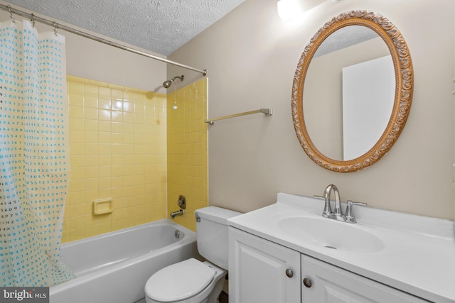 bathroom with shower / bath combo, a textured ceiling, toilet, and vanity