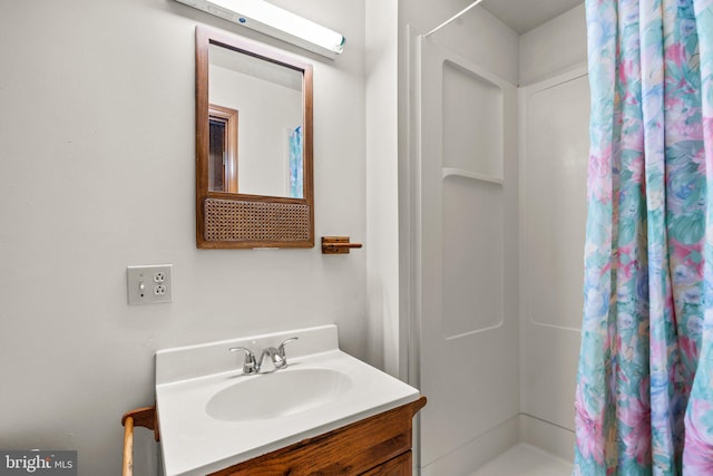 full bathroom with a shower stall and vanity