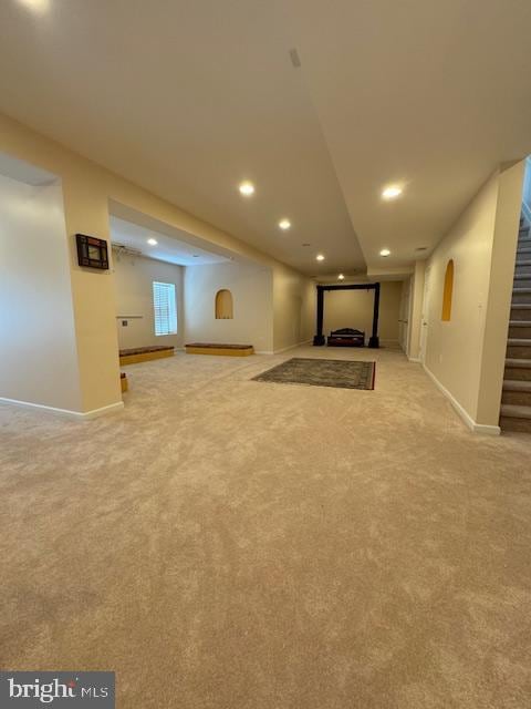 below grade area with stairway, recessed lighting, carpet, and baseboards