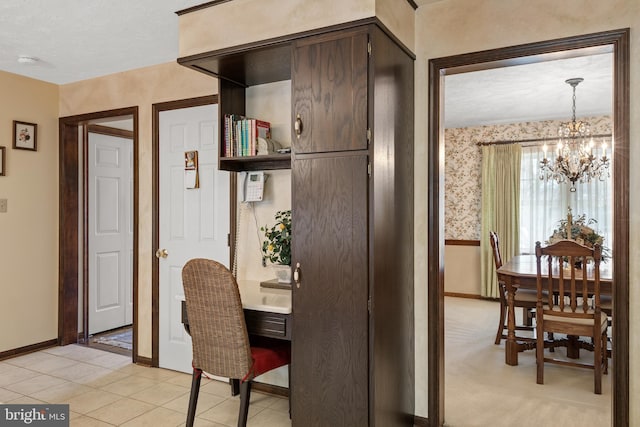 dining room featuring a chandelier, wallpapered walls, light tile patterned floors, and baseboards