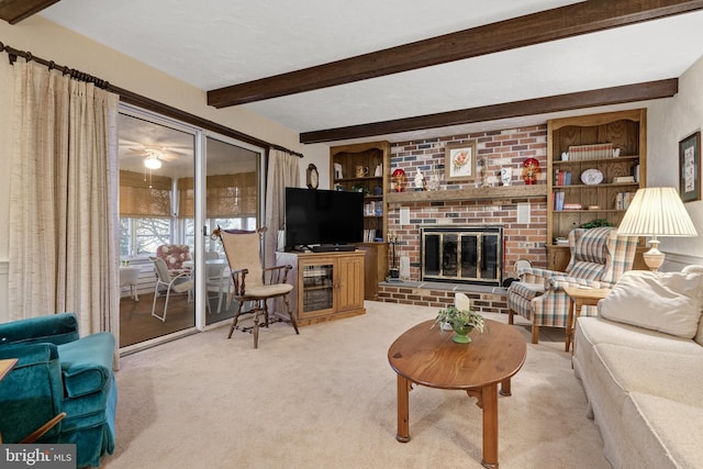 carpeted living room featuring built in shelves, beamed ceiling, and a fireplace