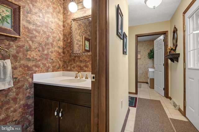 bathroom with visible vents, tile patterned flooring, vanity, and wallpapered walls