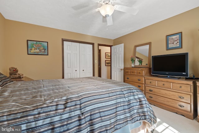 bedroom with carpet floors, a closet, and ceiling fan