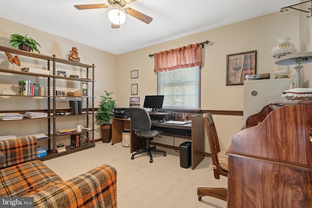 carpeted office featuring ceiling fan and baseboards