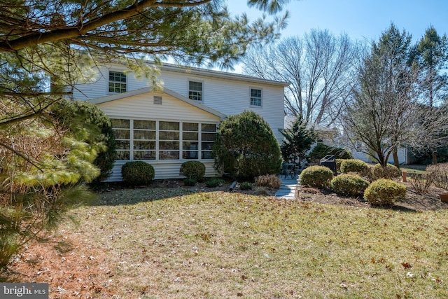 back of property with a sunroom