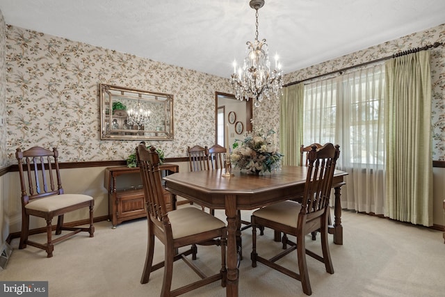 dining area featuring light carpet, wallpapered walls, baseboards, wainscoting, and an inviting chandelier