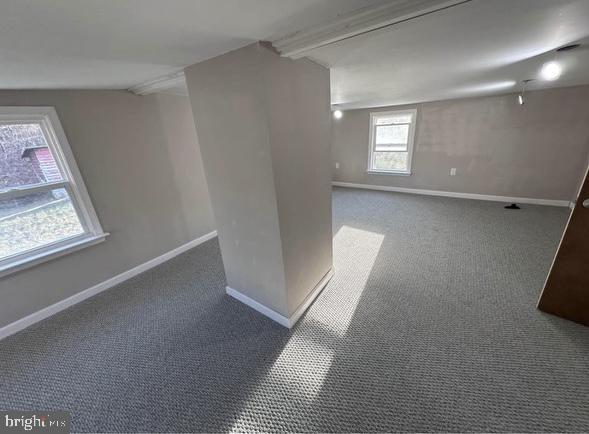 below grade area featuring carpet and baseboards