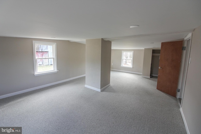 below grade area featuring carpet flooring and baseboards