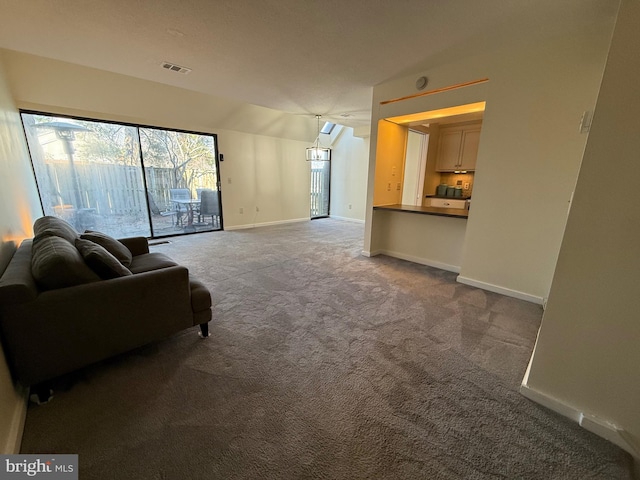 living room featuring carpet, visible vents, and baseboards