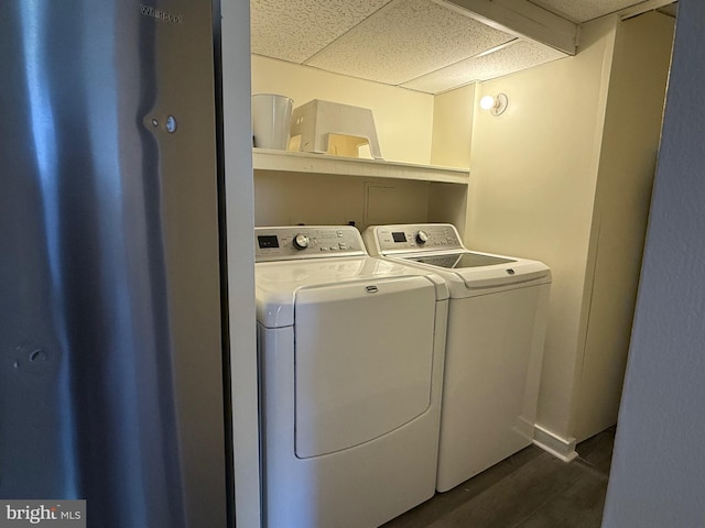 clothes washing area featuring dark wood-style floors and washer and dryer