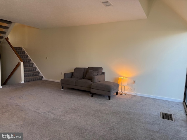 sitting room featuring carpet floors, visible vents, and stairs