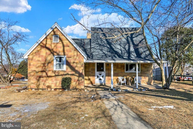 view of front of property featuring a shingled roof and a porch