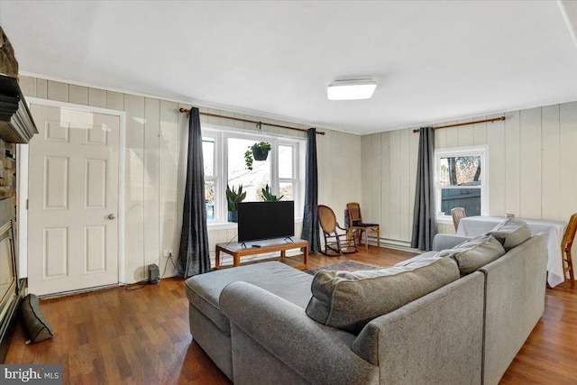 living room featuring dark wood-style floors and a healthy amount of sunlight