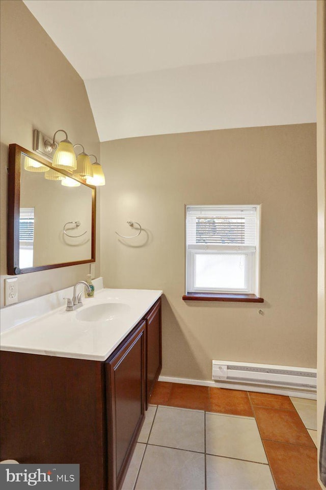 bathroom featuring lofted ceiling, a baseboard heating unit, vanity, baseboards, and tile patterned floors