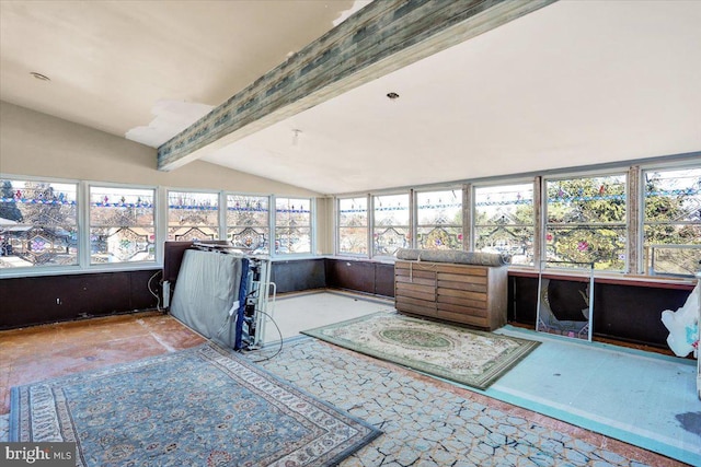 sunroom featuring lofted ceiling with beams