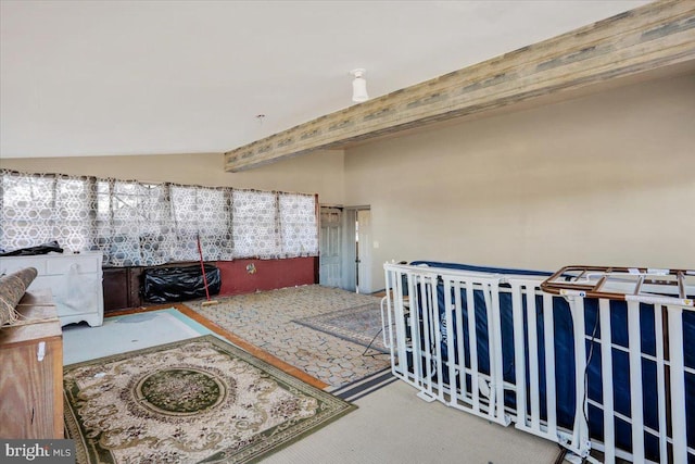 interior space featuring carpet flooring and beamed ceiling