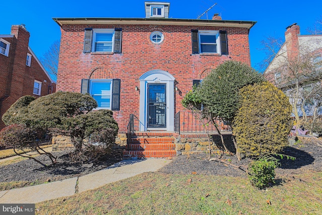 view of front of property featuring entry steps and brick siding