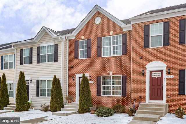 multi unit property featuring entry steps and brick siding