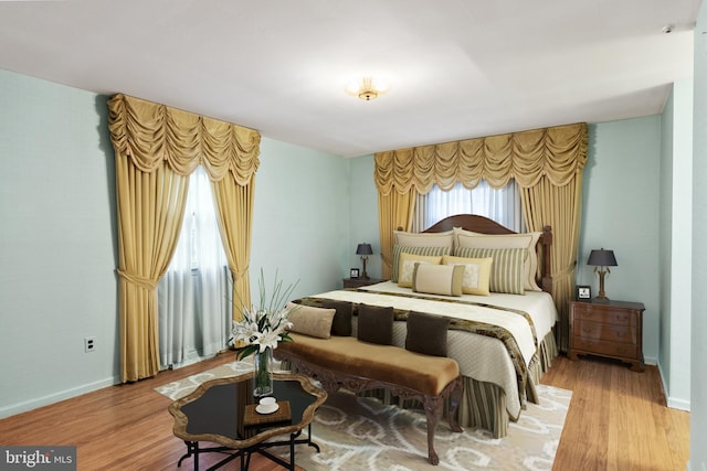 bedroom featuring wood finished floors and baseboards