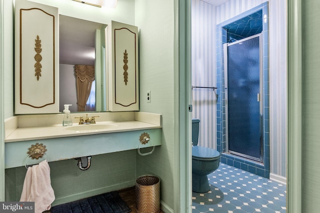 bathroom with toilet, a stall shower, and vanity