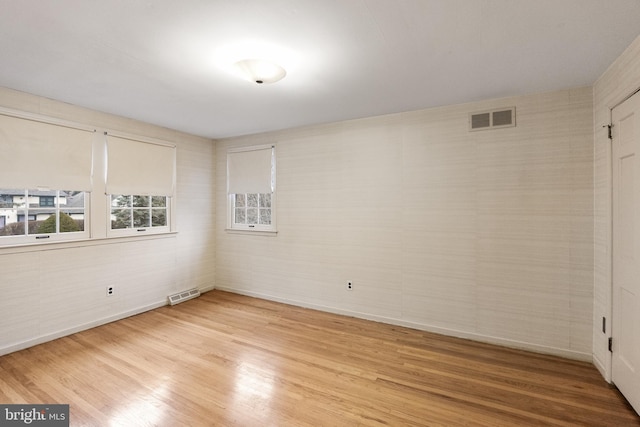 spare room with light wood-type flooring and visible vents