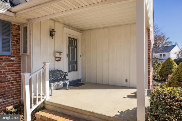 view of exterior entry with brick siding