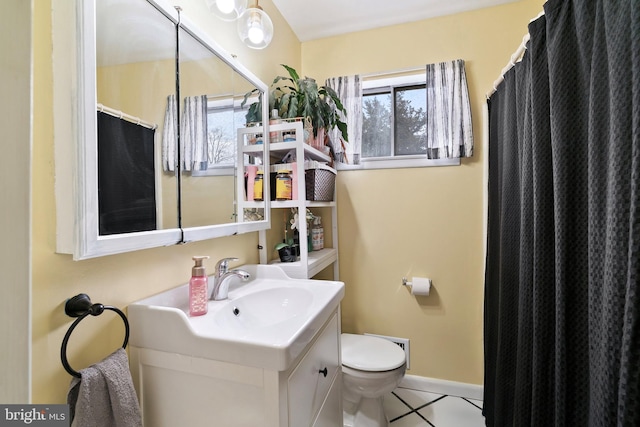 full bathroom featuring baseboards, vanity, toilet, and tile patterned floors