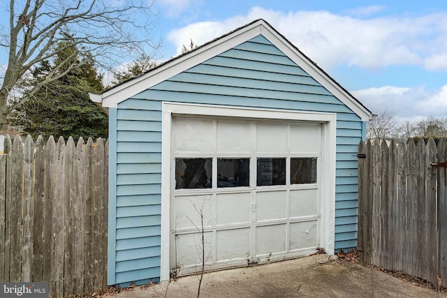 detached garage featuring fence