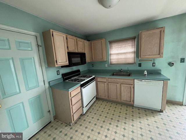 kitchen with white appliances, a sink, light floors, and light brown cabinetry