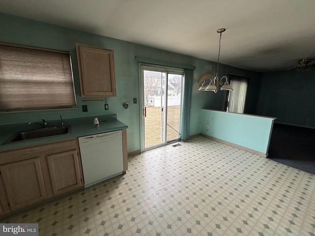 kitchen featuring pendant lighting, a notable chandelier, light floors, white dishwasher, and a sink